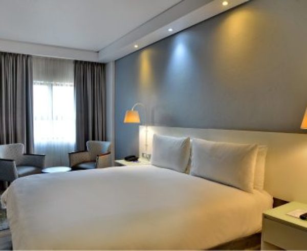 hotel room with bed and coffee table with chairs